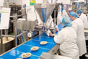 A view down the production line at a pie factory.